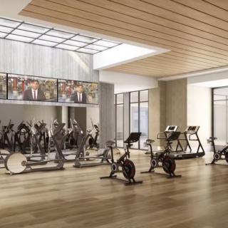 A modern and spacious gym with exercise bikes and treadmills.