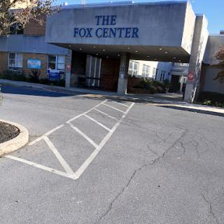 The entrance to The Fox Center, featuring a spacious parking lot.