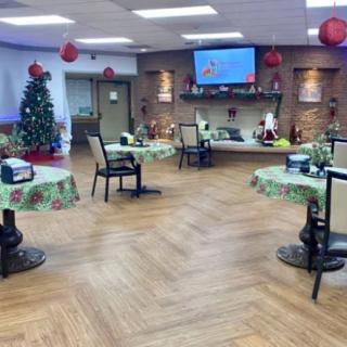 A festive dining area adorned with Christmas decorations and a beautifully decorated tree.