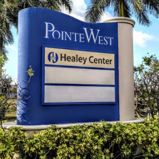 The sign for PointeWest featuring the Healey Center.