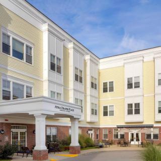 A multi-story residential building with a welcoming entrance and numerous windows.