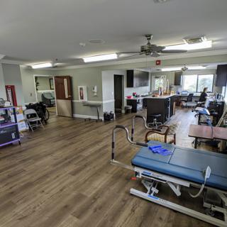 A spacious rehabilitation center equipped for physical therapy sessions.