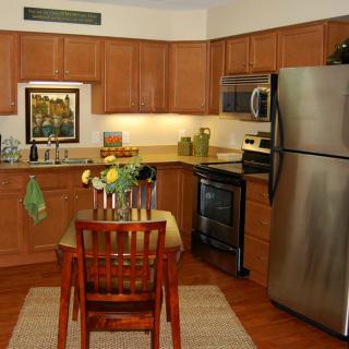 A cozy kitchen setup with wooden cabinets and a small dining area.
