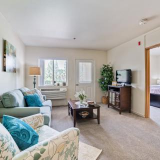 A cozy living room with comfortable seating, a television, and stylish decor.