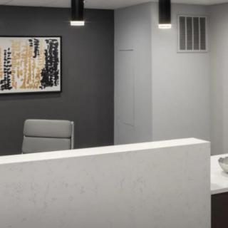 A modern office reception area with minimalist design and wall art.
