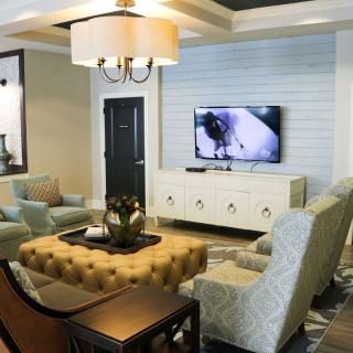 A modern living room with comfortable seating, a large TV, and stylish decor.