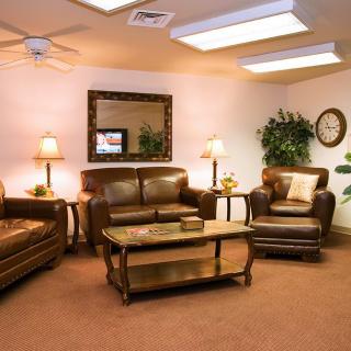 A cozy living room with leather seating, coffee table, and decorative accents.