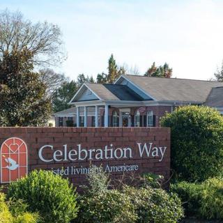 Sign for Celebration Way Retirement Community in a landscaped area.