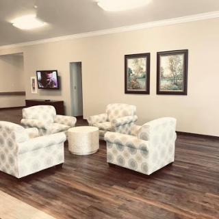 A cozy and inviting lobby space featuring comfortable seating and decorative artwork.