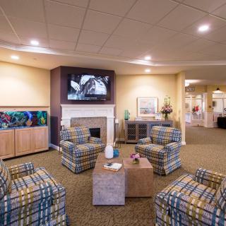 A cozy living room with a fireplace, television, and comfortable seating.