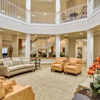 Spacious and elegant living room with modern furniture and an open balcony view.