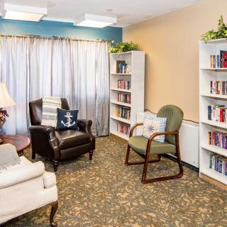 A cozy reading room with bookshelves and comfortable seating.