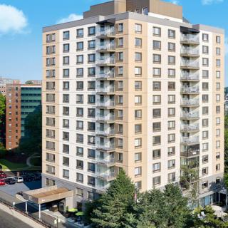 A modern residential apartment building in an urban setting.