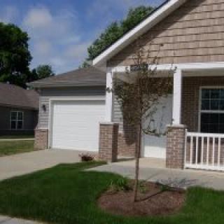 A suburban house with a garage and a small front yard.