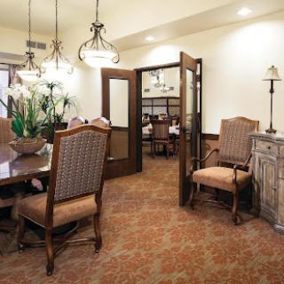A cozy dining area featuring elegant wooden furniture and soft lighting.