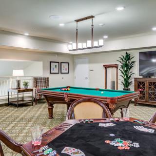 A cozy game room featuring a pool table and a poker table, ideal for leisure activities.