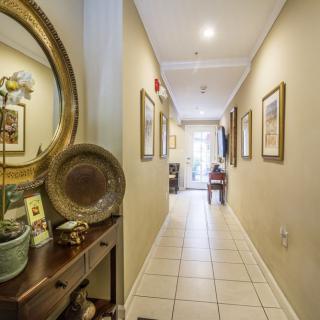 A well-lit hallway with decorative elements and artwork on the walls.