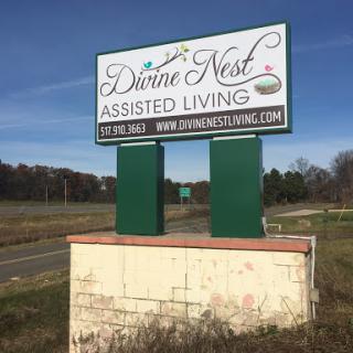 Sign for Divine Nest Assisted Living, indicating a facility dedicated to providing care and assistance.