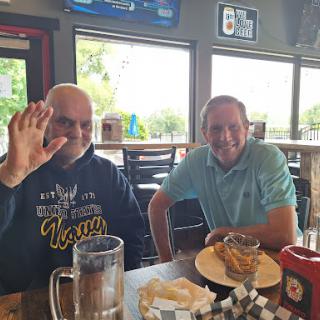 Two friends enjoying a casual meal together at a restaurant.