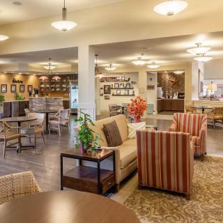 A cozy and modern lounge area with comfortable seating and warm lighting.