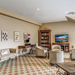 A cozy living room with elegant furniture and decorative artwork.