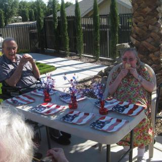 A small outdoor gathering with a patriotic-themed table setting.