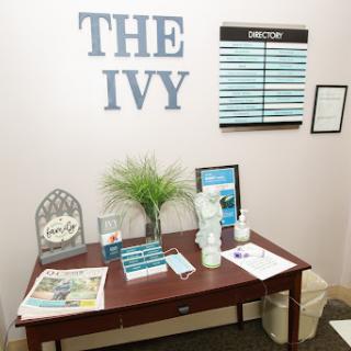 A cozy reception area featuring 'The Ivy' signage and a welcoming desk setup.
