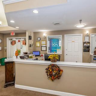A warmly decorated office reception area with autumn-themed accents.
