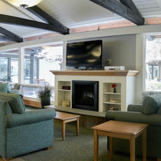 A cozy living room featuring a fireplace, comfortable seating, and a television.