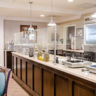 A buffet-style restaurant interior with serving stations and kitchen counters.