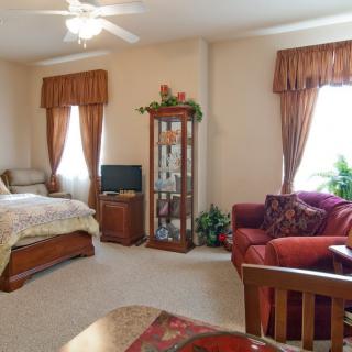 A cozy bedroom with elegant furnishings and warm decor.