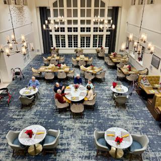 A spacious and elegantly designed dining area with tables set for guests.