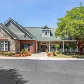 A charming residential building with a well-maintained exterior and landscaped surroundings.