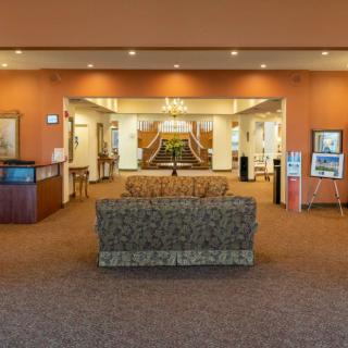 Spacious lobby with a reception desk and comfortable seating area.
