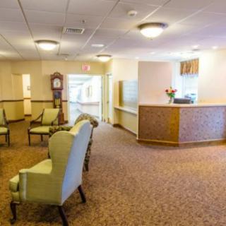 A spacious reception area with comfortable seating and a front desk.