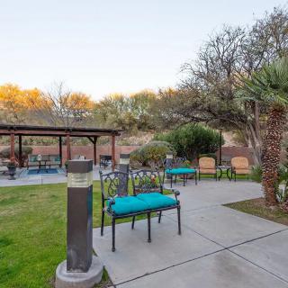 A tranquil outdoor patio area featuring seating and landscaping.