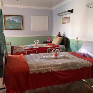 A tranquil massage room with well-arranged beds and towel art, providing a calming spa experience.