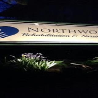 Sign for Northwood Rehabilitation & Nursing, illuminated at night.