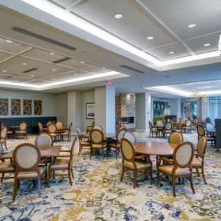 An elegant and modern dining area with neatly arranged tables and chairs.