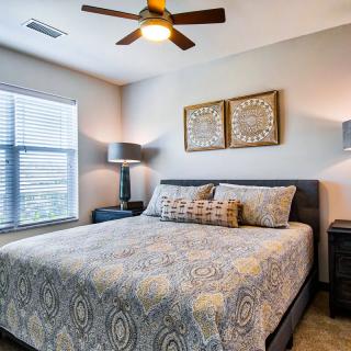 A modern bedroom with stylish decor, featuring a comfortable bed and elegant furnishings.
