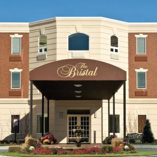 Entrance to a senior living facility with a prominent awning.