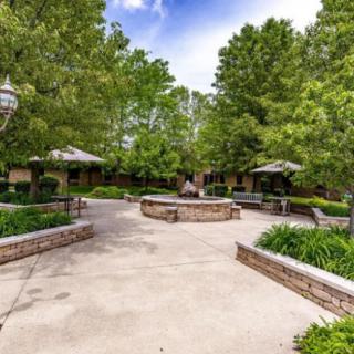 A tranquil outdoor patio with benches and greenery, providing a serene setting for relaxation.