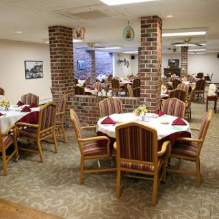 A spacious dining area featuring elegantly set tables and a cozy atmosphere.