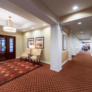 Spacious hotel lobby featuring elegant seating and warm lighting.