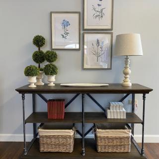 A stylish console table adorned with decorative elements and art.