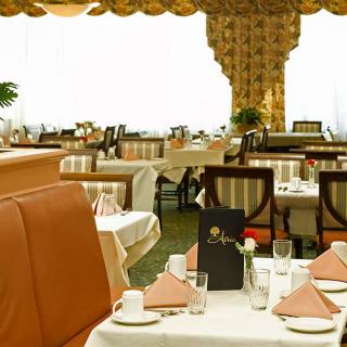 Elegant dining area with neatly arranged tables and classic decor.