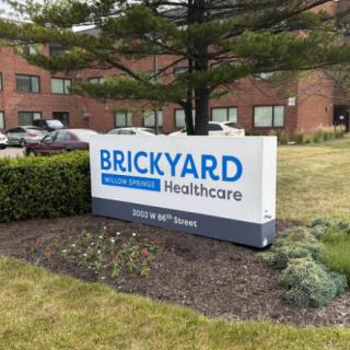 Brickyard Healthcare facility sign located in front of a brick building.