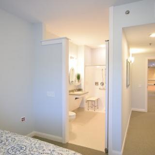 A modern bedroom with an open layout connecting to a stylish bathroom.