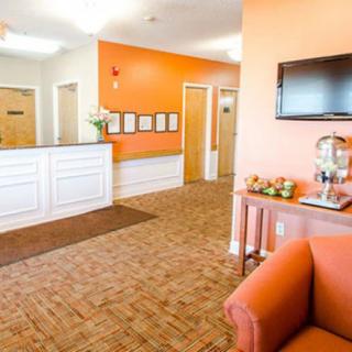 A welcoming lobby with orange accents and comfortable seating.