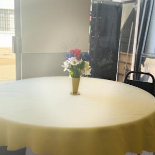 A cozy dining setup featuring a round table with a colorful flower arrangement.